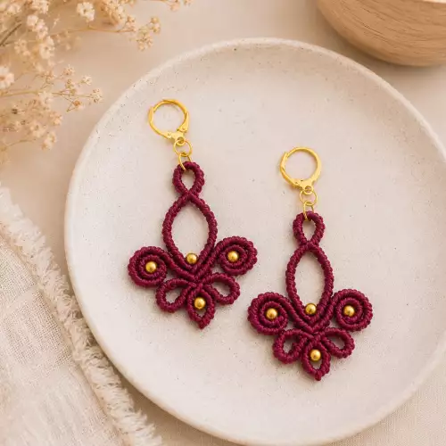 Aretes lotos artesanales tono vino con detalles dorados