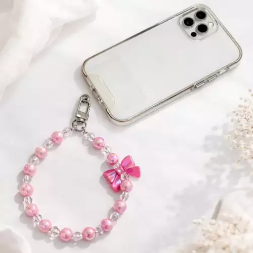 Correa strap para celular con adorno moño rosa chicle y piedras