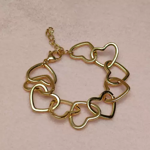 Pulsera corazones entrelazados dorada en rodio