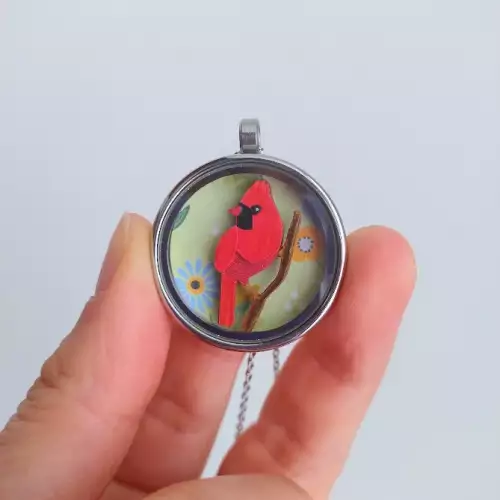 Relicario cardenal en acero inoxidable colección alado
